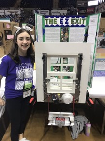 Abigail poses with her invention prototype and display board.